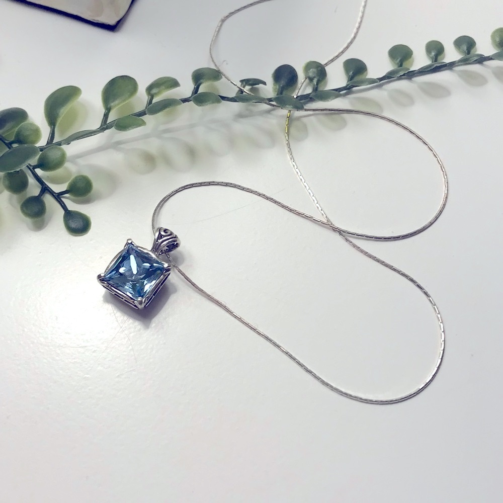 Sterling Silver w/ box chain and blue Quartz. Size is 18”